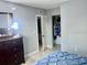 Neutral bedroom featuring a walk-in closet and a dresser with mirror, promoting organization at 731 Wyman Ct # 731-A, Orlando, FL 32809