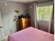 Cozy bedroom with a window, dresser, and a calming atmosphere for rest and relaxation at 731 Wyman Ct # 731-A, Orlando, FL 32809