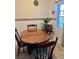 Dining area with wooden table and chairs, and a view from the window at 731 Wyman Ct # 731-A, Orlando, FL 32809