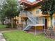 Condo with an outdoor staircase and green landscaping surrounding the building at 731 Wyman Ct # 731-A, Orlando, FL 32809