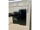 Functional kitchen features white cabinets, a black range, and a refrigerator at 731 Wyman Ct # 731-A, Orlando, FL 32809