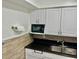 Compact kitchen features granite counters, white cabinets, and microwave at 731 Wyman Ct # 731-A, Orlando, FL 32809