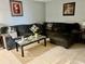 Inviting living room features a plush sectional sofa, area rug, and natural light at 731 Wyman Ct # 731-A, Orlando, FL 32809