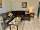 This living room is furnished with a sectional sofa and has neutral decor at 731 Wyman Ct # 731-A, Orlando, FL 32809