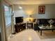 Bright living room featuring a large window, comfortable sofa, and media console at 731 Wyman Ct # 731-A, Orlando, FL 32809
