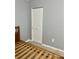 Bedroom featuring tile flooring, grey walls, a wooden bed frame, and a double-door closet at 731 Wyman Ct # 731-A, Orlando, FL 32809