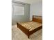 An empty bedroom with neutral walls, light tile floors, and a wood bed frame at 731 Wyman Ct # 731-A, Orlando, FL 32809