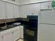 Kitchen with white cabinets, black countertops and appliances at 731 Wyman Ct # 731-A, Orlando, FL 32809