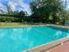 Large recreational outdoor pool for community residents, with trees and foliage in background at 731 Wyman Ct # 731-A, Orlando, FL 32809