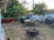 Backyard featuring a dining table, fire pit, and mature trees, perfect for entertaining at 7624 Udine Ave, Orlando, FL 32819