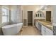 Bright bathroom with soaking tub and double sink vanity at 784 Seneca Trl, St Cloud, FL 34772