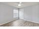 Bright bedroom features a ceiling fan, window with blinds, and light-colored wood flooring at 784 Seneca Trl, St Cloud, FL 34772