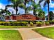 Elegant brick entrance sign for Indian Lakes surrounded by lush landscaping, offering a welcoming first impression at 784 Seneca Trl, St Cloud, FL 34772