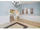 Inviting entryway with tile flooring, arches, modern artwork and chandelier at 784 Seneca Trl, St Cloud, FL 34772