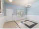 Inviting entryway featuring tile flooring, blue walls, natural light, and stylish chandelier at 784 Seneca Trl, St Cloud, FL 34772