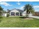 Beautifully landscaped front yard featuring a charming one story home with stone accents and a two-car garage at 784 Seneca Trl, St Cloud, FL 34772