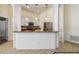 Open-concept kitchen with white cabinets, granite countertops, and modern stainless steel appliances at 784 Seneca Trl, St Cloud, FL 34772