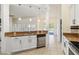 Bright kitchen features granite countertops and stainless steel dishwasher at 784 Seneca Trl, St Cloud, FL 34772