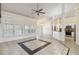Spacious living room features tile floors, ceiling fan, white trim and access to kitchen at 784 Seneca Trl, St Cloud, FL 34772