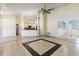 Open living and kitchen area with tile flooring, white columns, and a ceiling fan at 784 Seneca Trl, St Cloud, FL 34772