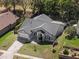 Charming home featuring a well-maintained lawn, a cozy front entry, and a convenient two-car garage at 834 High Pointe Cir, Minneola, FL 34715