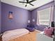 Bright bedroom with a window, comfortable chair, and playful decor at 834 High Pointe Cir, Minneola, FL 34715
