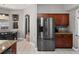 Bright kitchen featuring stainless steel refrigerator, granite countertops, and eat-in nook at 834 High Pointe Cir, Minneola, FL 34715