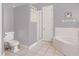 Bathroom featuring a soaking tub, enclosed shower, and toilet at 834 High Pointe Cir, Minneola, FL 34715