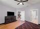 Spacious main bedroom with dark wood furnishings and a view of the ensuite bathroom at 834 High Pointe Cir, Minneola, FL 34715