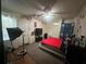 Bedroom featuring a queen-size bed with red comforter and dark gray carpet at 837 Quintilian Ave, Orlando, FL 32809