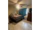 Bedroom featuring ceramic floors, ceiling fan, tv, and a queen-sized bed at 837 Quintilian Ave, Orlando, FL 32809