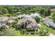 Expansive estate aerial view highlights lush landscaping and stunning water feature views at 8550 Lost Cove Dr, Orlando, FL 32819