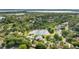 A scenic aerial shot showcases the neighborhood's lush surroundings and beautiful lake at 8550 Lost Cove Dr, Orlando, FL 32819