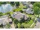 An aerial view shows a house with a pool and lake views at 8550 Lost Cove Dr, Orlando, FL 32819