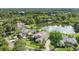 An aerial view of a property with a serene lake and lush trees surrounding at 8550 Lost Cove Dr, Orlando, FL 32819