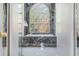 Large stained glass window provides privacy and enhances the beauty of the bathtub at 8550 Lost Cove Dr, Orlando, FL 32819