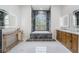Bright bathroom features marble accents, a large soaking tub, and double sinks at 8550 Lost Cove Dr, Orlando, FL 32819