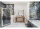 Elegant bathroom has marble topped vanity, marble accents and glass enclosed shower at 8550 Lost Cove Dr, Orlando, FL 32819