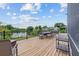A spacious wooden deck offers a serene view of the tranquil lake at 8550 Lost Cove Dr, Orlando, FL 32819