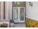 Elegant entrance featuring glass doors, decorative pillars, and vibrant flowering bushes at 8550 Lost Cove Dr, Orlando, FL 32819