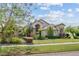 Beautiful property boasts a vibrant landscaped front yard with mature trees and blooming flowers at 8550 Lost Cove Dr, Orlando, FL 32819