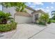 Attached garage with a neutral door, surrounded by greenery and a well-maintained driveway at 8550 Lost Cove Dr, Orlando, FL 32819