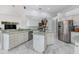 Bright kitchen with stainless steel appliances, center island, and marble tile floors at 8550 Lost Cove Dr, Orlando, FL 32819