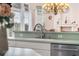 Kitchen sink and counter featuring stainless steel dishwasher, stylish faucet and green counter at 8550 Lost Cove Dr, Orlando, FL 32819
