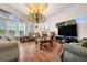 Ornate living room with chandelier, hardwood floors, large windows, and unique decorations at 8550 Lost Cove Dr, Orlando, FL 32819