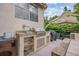 Outdoor kitchen with built-in grill, countertop space, and storage for convenient al fresco dining at 8550 Lost Cove Dr, Orlando, FL 32819