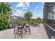 Outdoor seating area on patio with multiple tables and chairs, greenery, and screened enclosure at 8550 Lost Cove Dr, Orlando, FL 32819