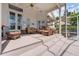 Relaxing covered patio featuring comfortable seating arrangements, ceiling fan, and serene outdoor views at 8550 Lost Cove Dr, Orlando, FL 32819