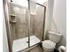 A modern bathroom with a tiled shower, glass door, and contemporary fixtures offers a spa-like experience at 9122 Sommerset Hills Dr, Davenport, FL 33896