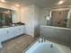 Modern bathroom with a soaking tub, walk-in shower, and double vanity sinks at 9122 Sommerset Hills Dr, Davenport, FL 33896
